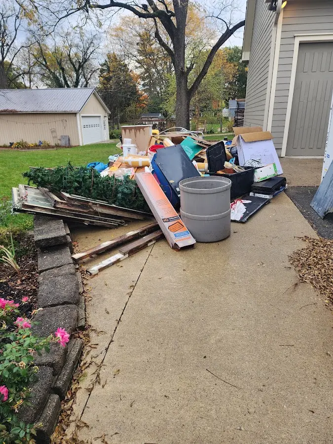 Dumpster being loaded with debris for Commercial Dumpster Rental in Mineola